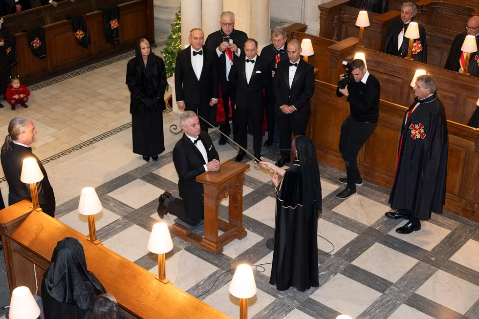 The Grand Master reading during an investiture ceremony